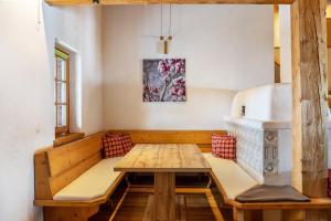 a dining room with a wooden table and benches at Apartment Kracherlemoos in Seefeld in Tirol