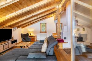 a living room with a couch and a tv at Apartment Kracherlemoos in Seefeld in Tirol
