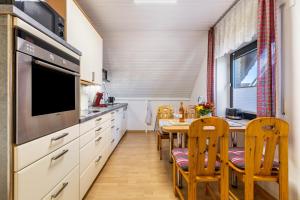 a kitchen with a table and a dining room at Ferienwohnung Luri in Gangelt +23 photos