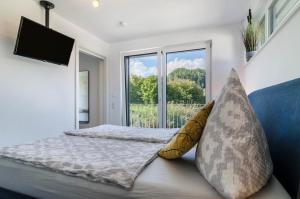 a bedroom with a bed and a large window at Landtraum 17 in Wittenhofen
