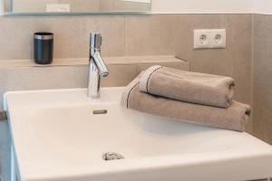 a sink with a faucet and two towels on it at Landtraum 17 in Wittenhofen