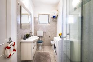 a bathroom with a toilet and a sink and a shower at Villa Aurea Retreat Lux in Porto Cesareo +25 photos