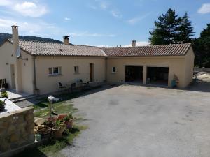 a building with a parking lot in front of it at Gîte À La Campagne in Bourdeaux