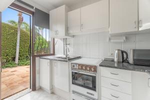 a kitchen with a stove top oven next to a window at Casa Mara in Sauzal