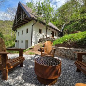 a group of chairs and a table in front of a building at Juaniz in Tolmin