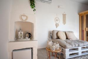 a living room with a couch and a fireplace at Dimora Giulia Luxury Suite and Room in Castellana Grotte +39 photos