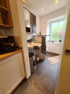a bathroom with a sink and a mirror and a tub at Rosenzauber Kraxler Pärchen in Weißenstadt +29 photos