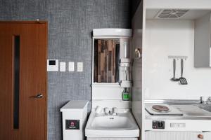 a small kitchen with a sink and a counter at Silk Court 402 in Chitose +35 photos