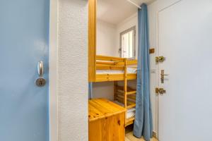 a room with bunk beds and a door at Les Saules in Le Grau-dʼAgde