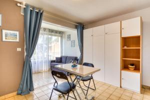 a living room with a table and chairs at Les Saules in Le Grau-dʼAgde