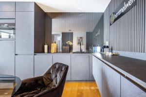 a bar with a chair in a room at Apartment Himmelweit in Freyung +29 photos