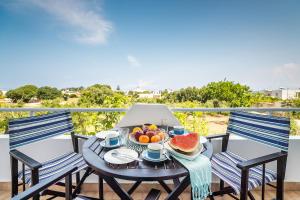 a table with a bowl of fruit on a balcony at La Christine in Rhodes Town