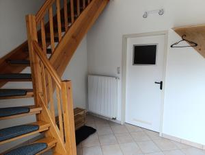 a room with a wooden staircase and a door at Zirbelkiefer 8 in Bad Klosterlausnitz