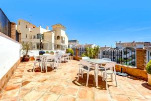 a patio with tables and chairs on a balcony at Studio Torreblanca close to beach in Fuengirola