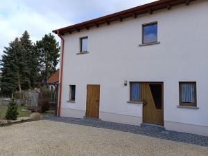 a white house with two doors and a driveway at Zirbelkiefer 8 in Bad Klosterlausnitz