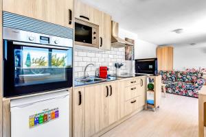 a kitchen with a sink and a microwave at Studio Torreblanca close to beach in Fuengirola