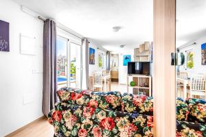 a living room with a couch and a window at Studio Torreblanca close to beach in Fuengirola