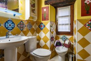 a bathroom with a toilet and a sink at Teixo in Vega de Logares +34 photos
