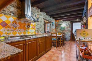 a kitchen with a sink and a refrigerator at Teixo in Vega de Logares