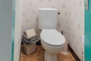 a bathroom with a toilet and a trash can at Logis des Tilleuls in Saint-Mathieu +14 photos