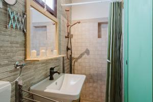 a bathroom with a sink and a mirror and a shower at Casa Roberta in Granitola +23 photos