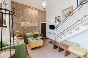 a living room with a brick wall and stairs at Casa Roberta in Granitola