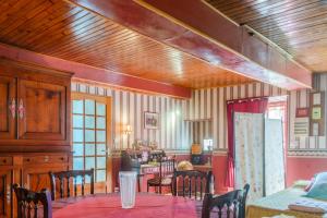 a dining room with a table and chairs at Logis des Tilleuls in Saint-Mathieu