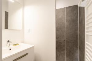 a bathroom with a sink and a shower at L'écrin De La Sèvre in Cugand +12 photos