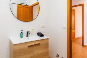 a bathroom with a sink and a mirror on the wall at Es Port in Cala Ratjada +22 photos
