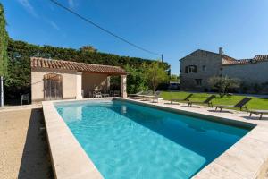 a swimming pool in front of a house at Mas De Charme Caumont Sur Durance in Caumont-sur-Durance