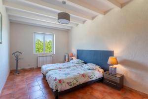 a bedroom with two beds and a window at Mas De Charme Caumont Sur Durance in Caumont-sur-Durance +20 photos
