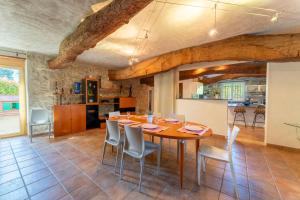 a kitchen and dining room with a table and chairs at Mas De Charme Caumont Sur Durance in Caumont-sur-Durance