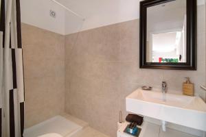 a bathroom with a sink and a mirror at Large apartment in Vale do Lobo in Almancil +28 photos