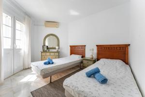 a bedroom with two beds and a mirror at Casa Karma in Mijas +23 photos