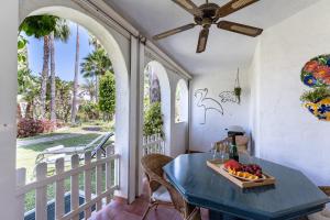 a table with a bowl of fruit on a balcony at Casa Karma in Mijas