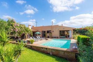 a villa with a swimming pool and a house at Ses Serres in Santanyi