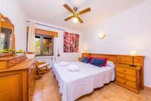a bedroom with a bed and a ceiling fan at Ses Serres in Santanyi +19 photos