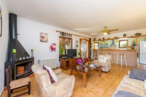 a living room with a couch and a fireplace at Ses Serres in Santanyi
