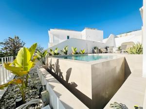 a swimming pool on the roof of a house at Casa Blanca in Torre del Mar