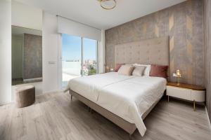 a bedroom with a large bed and a large window at Casa Blanca in Torre del Mar +25 photos