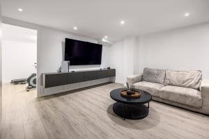 a living room with a couch and a flat screen tv at Casa Blanca in Torre del Mar