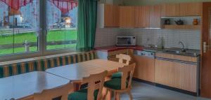 a kitchen with a table and chairs and a sink at Landlhof in Ramsau