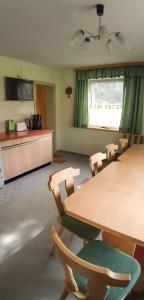 a conference room with a table and chairs and a kitchen at Landlhof in Ramsau +7 photos