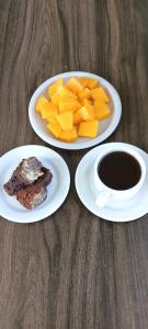 a table with two plates of food and a cup of coffee at Cozzee AnD in Labuan Bajo
