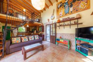 a living room with a couch and a staircase at Acuario-Géminis in Llucmajor