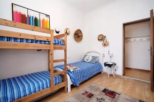 a room with two bunk beds and a chair at Villa Lardarina in Corniglia