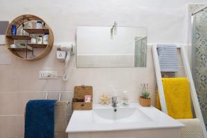 a bathroom with a sink and a mirror at Villa Lardarina in Corniglia +22 photos