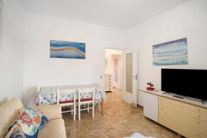 a living room with a couch and a table with chairs at Albenga Mary 43 6 in Albenga