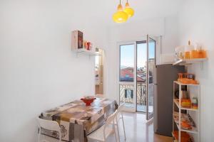 a kitchen with a table and a refrigerator at Albenga Mary 43 6 in Albenga