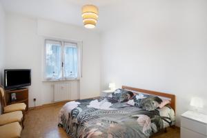 a bedroom with a bed with two dogs laying on it at Albenga Mary 43 6 in Albenga